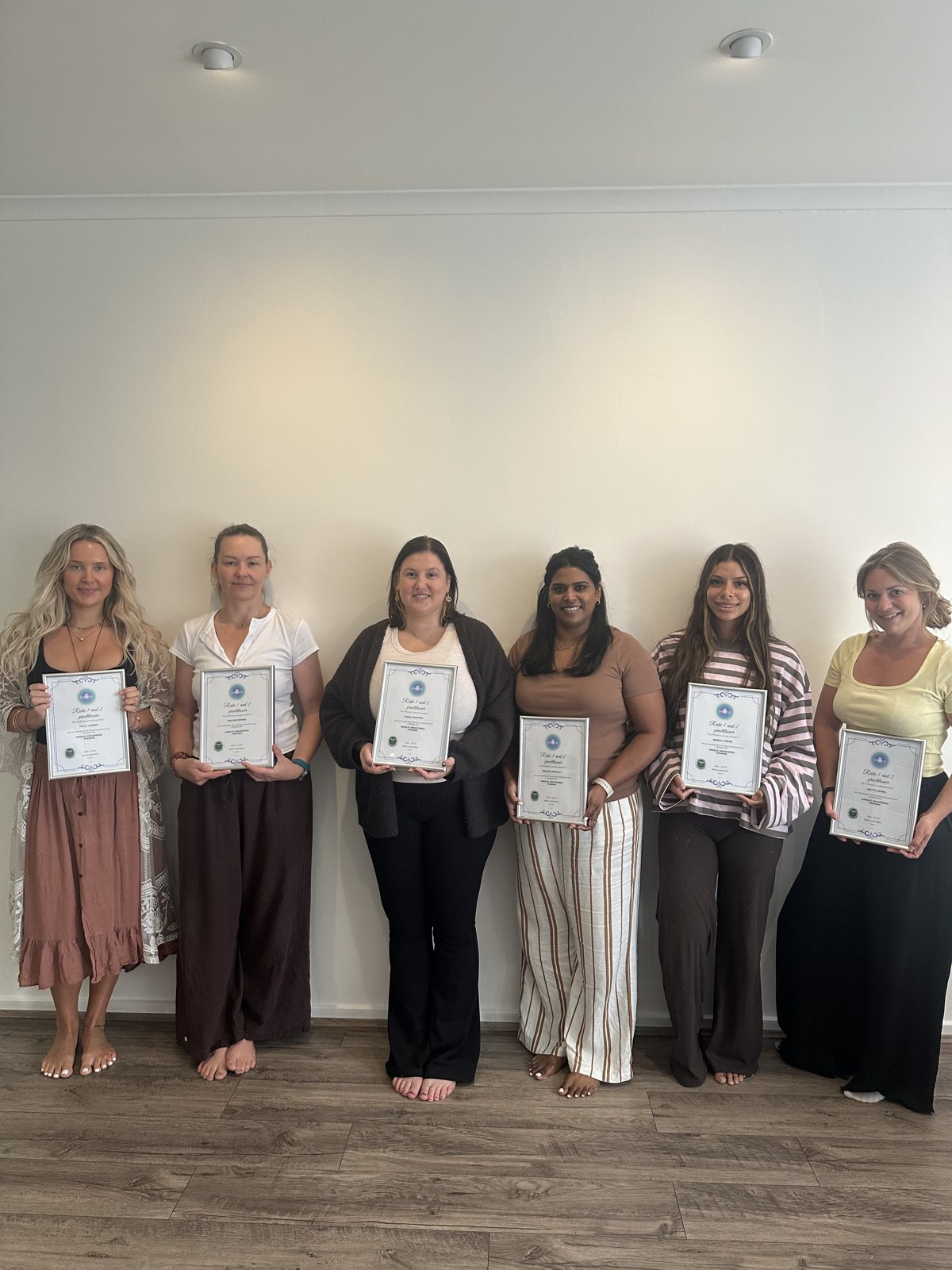 Reiki 1 and 2 graduates holding their certificates