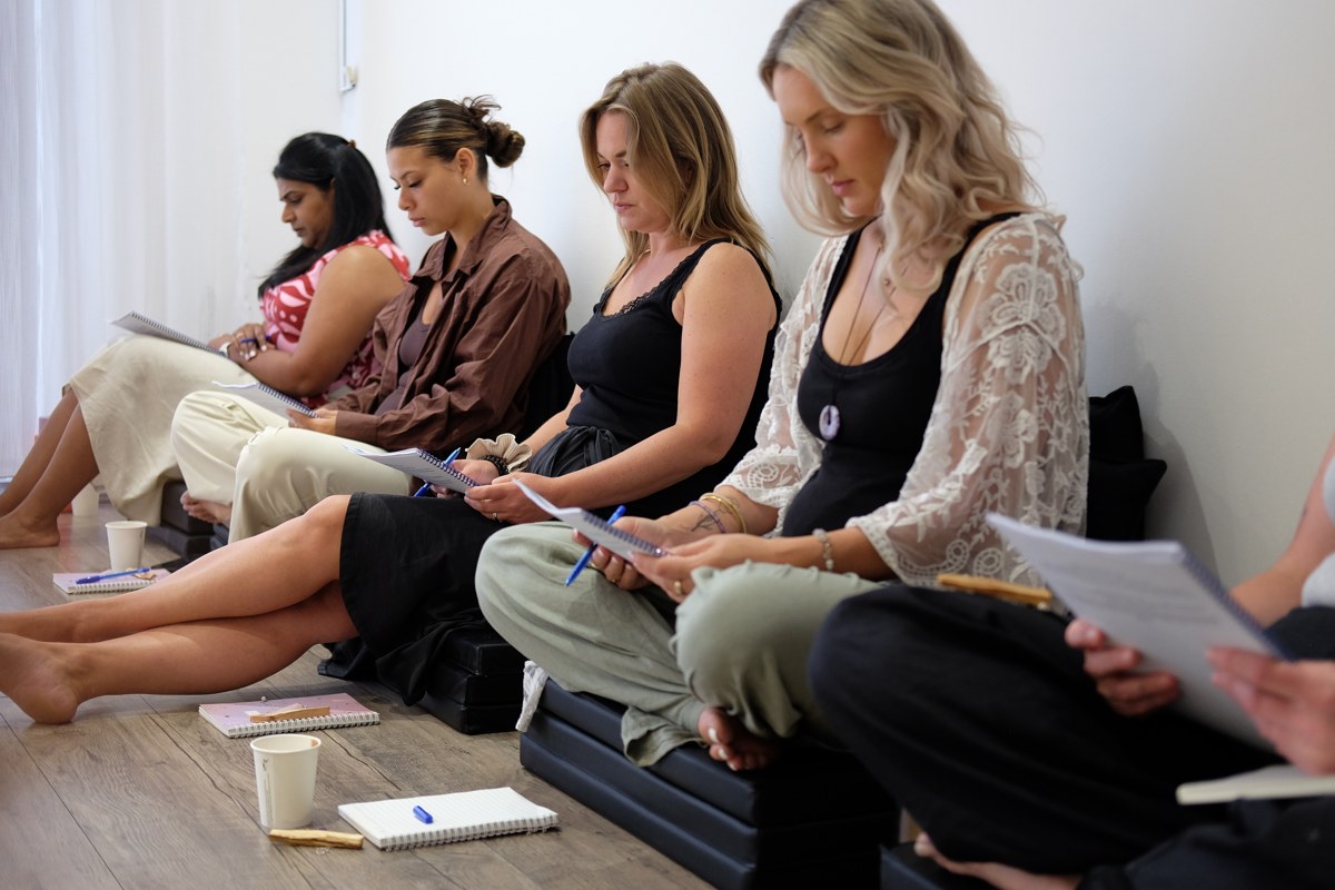 Students taking notes during Reiki training